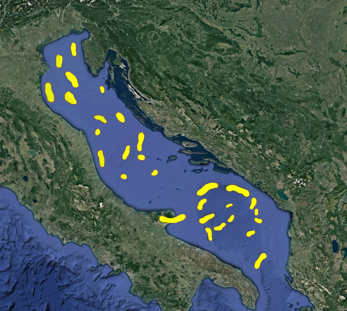 X-Vision satellite survey result; yellow patches marking localized hydrocarbon expressions over an offshore basin